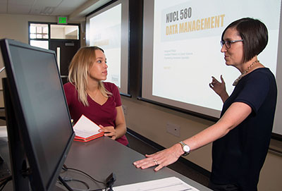 Assistant Professor of Library Science and Engineering Information Specialist, Margaret Phillips, discussing data management with NUCL 580 student.
